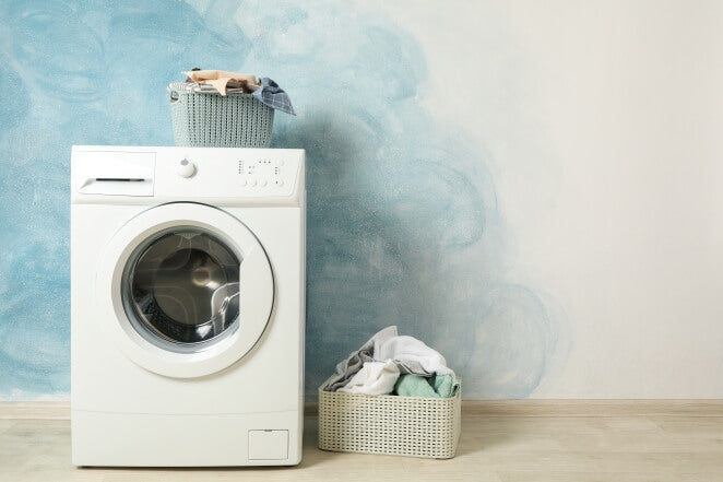 Modern freestanding washing machine in a stylish home, representing washing machines Northern Ireland households rely on daily.