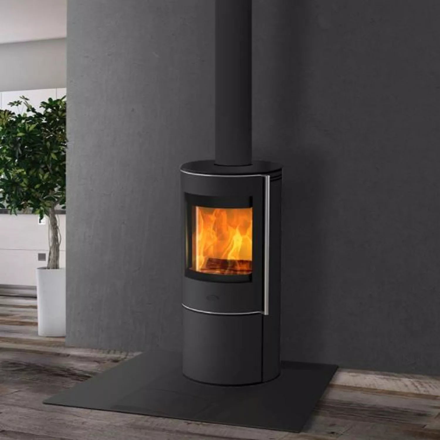 Modern black wood stove with visible flames against a gray wall.