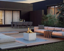 Modern outdoor patio with fire pit, seating area, and dining table.
