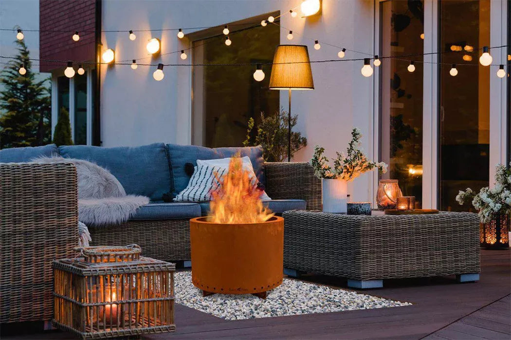 Outdoor patio with fire pit, seating area, and string lights