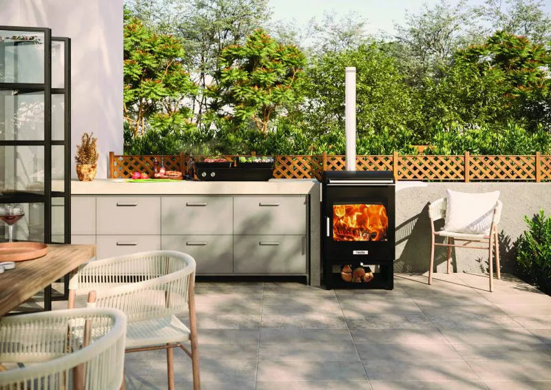 Outdoor kitchen with a wood-fired oven and garden view