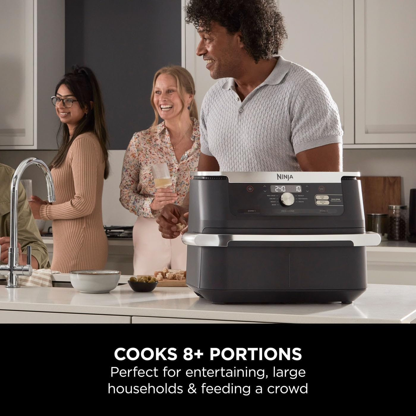 Ninja foodie appliance on a kitchen counter with people around