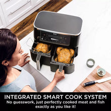 Woman using a Ninja air fryer with perfectly cooked food, kitchen setting.