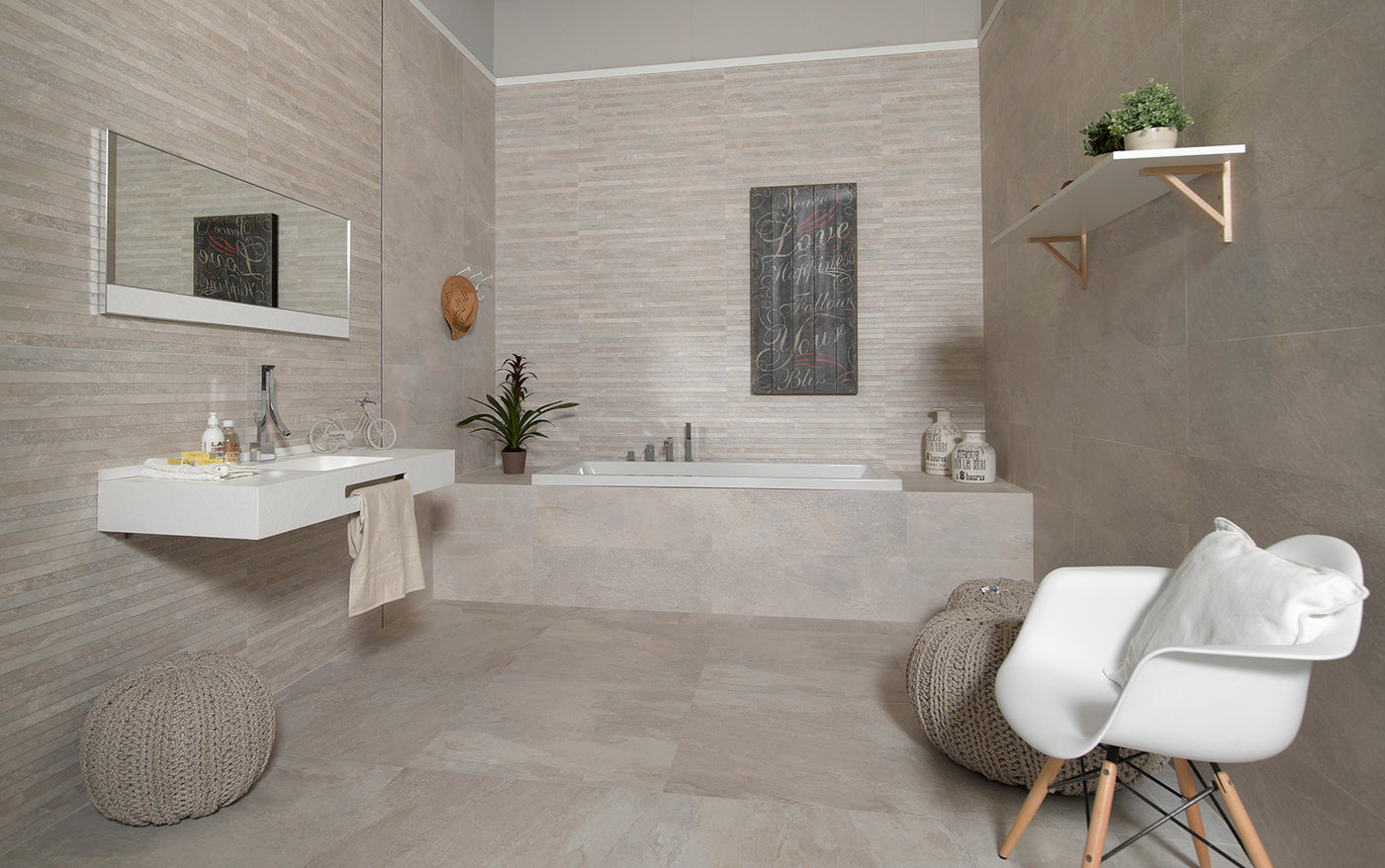 Modern bathroom with a bathtub, sink, and decorative elements.