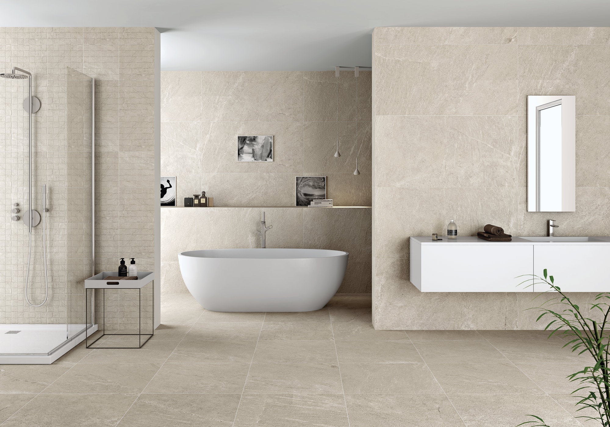 Modern bathroom with beige tiles, a freestanding bathtub, and a sink.